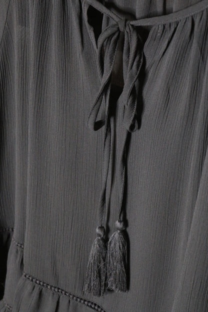 Black Tiered Ruffled Blouse with Tassels and Crochet details.